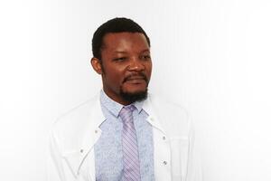 Serious black doctor man with small beard in white coat bright shirt isolated on white background photo