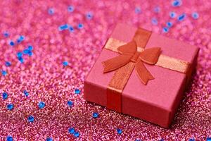 Red gift box in festive tinsel photo