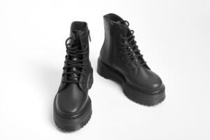 Black women combat boots on high heel platform with lug soles on isolated white background photo