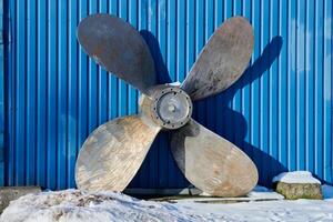 Old boat propeller deteriorate in boat yard photo