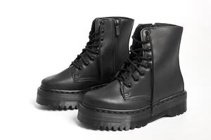 Black women combat boots on high heel platform with lug soles on isolated white background photo