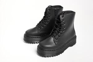 Black women combat boots on high heel platform with lug soles on isolated white background photo