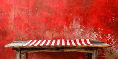 Vintage Wooden Table Against Textured Red Wall with Striped Tablecloth photo