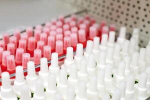 White plastic bottles with glue on shelf in store photo