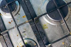 Dirty stove top with oil splatters, fat stains and food leftovers photo