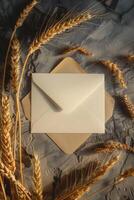 A white envelope sits on a table with a bunch of wheat photo