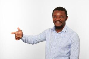 Happy african american black man with pointing finger in casual bright shirt isolated background photo