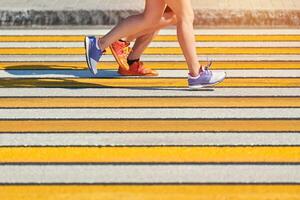 Woman running crosswalk, copy space photo