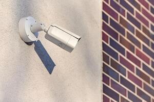 IP CCTV security camera on concrete wall, urban cityscape photo