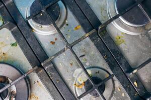 Dirty gas stove with food leftovers and crumbs photo