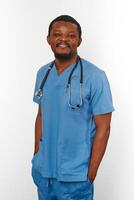 Smiling black surgeon doctor bearded man in blue coat with stethoscope isolated on white background photo