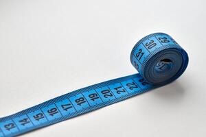 Blue measuring tape isolated on white background photo