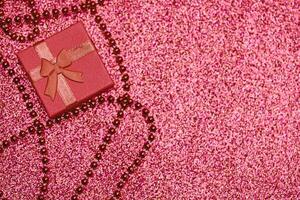 Red gift box in festive tinsel photo