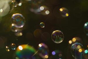 Magical Soap Bubbles Floating with Colorful Light Bokeh Background photo