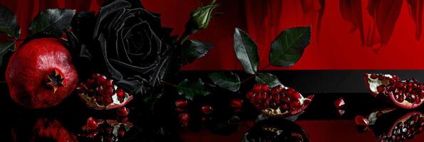 Dramatic Noir Still Life with Black Rose and Red Pomegranate photo