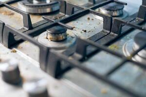 Dirty gas stove with food leftovers and crumbs photo