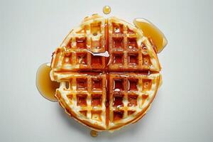 Top view of a waffle with mapple syrup on white background photo