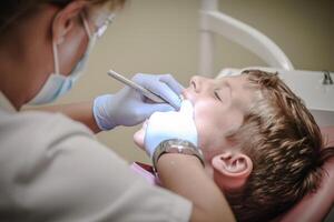 A dentist doing scaling to a young boy photo