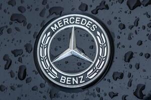 Gasiveren Cyprus 03.23.2024 - Symbol of Mercedes Benz is installed on the hood of the car covered by water drops. photo