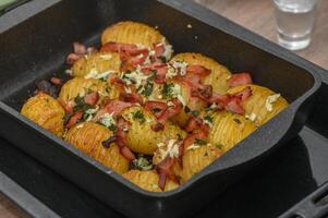 baked potatoes with bacon in the kitchen 2 photo