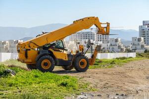 yellow front loader goes to a construction site 1 photo