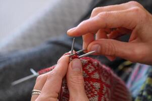 woman's hands knit a sock with knitting needles. close-up 4 photo