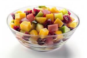 a clear bowl of cube mix fruits on white background photo