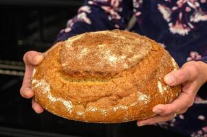 appetizing homemade whole grain bread in the hands of a woman 11 photo