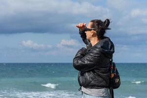 woman looking into the distance on the shores of the Mediterranean Sea 1 photo