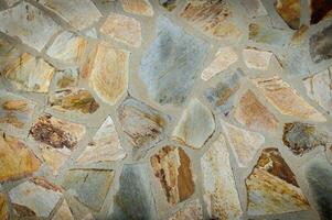 Stone wall texture background - grey stone siding with different sized stones 1 photo