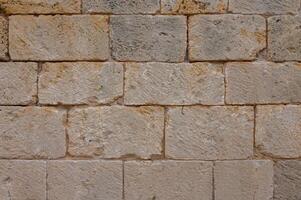 textura de un antiguo ladrillo pared hecho de arenisca. arqueológico excavaciones 1 foto