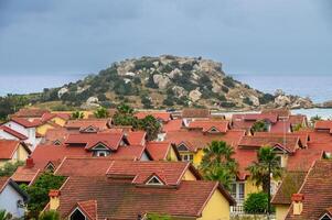 complex of houses with red roofs against the backdrop of the sea in Northern Cyprus 19 photo