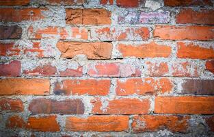 Old and aged red brick wall texture background with vignetting photo