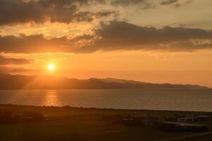 the sun sets behind the mountains in winter in Cyprus 1 photo