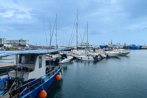 LIMASSOL, CYPRUS - APRIL 15, 2024 Old port of Limassol with beautiful fishing boats at sunset photo