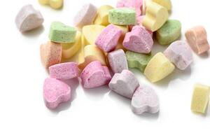 Pink and purple heart shaped candies. Valentine's day background. photo