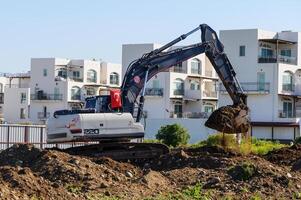 Excavator digging soil at a construction site 1 photo