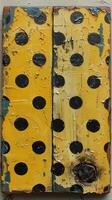 Weathered Beauty. A Close-Up of a Vintage Yellow Domino Piece photo