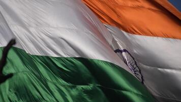 India flag flying high at Connaught Place with pride in blue sky, India flag fluttering, Indian Flag on Independence Day and Republic Day of India, tilt up shot, Waving Indian flag, Har Ghar Tiranga video