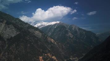 Tibetan green mountains in the clouds during the day, drone view video