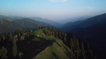 Tibetan green mountains in the clouds during the day, drone view video