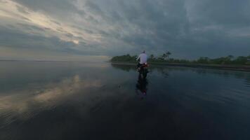 Motorcyclist riding on black beach on motorcycle video