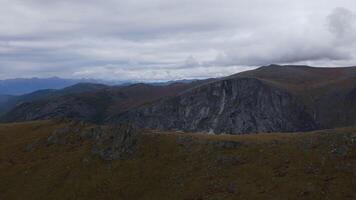 Aerial view slope Altai Mountains covered with clouds under gloomy sky autumn video