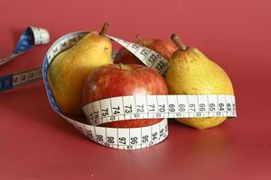 Tape measure and apple symbolizing diet and obesity photo