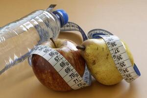 Apple and pear fruits representing forms of obesity photo