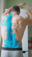 Male Athletic Back with Kinesio Tape After Sports Massage and Vacuum Therapy video