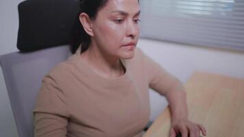 Close-up of Asian woman working at home using IT chat ball system commands running on desktop computer. Experts in creating innovative software Engineers are developing apps and motivational programs. video