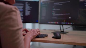 Close-up of Asian woman working on desktop computer in startup office Experts are coding software for Big Data Blockchain projects. video