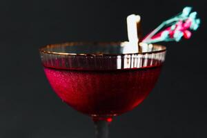 Alcoholic drink. A cocktail with elite alcohol on dark black background photo