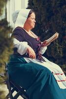 Portrait of brunette woman dressed in historical Baroque clothes with old fashion hairstyle photo